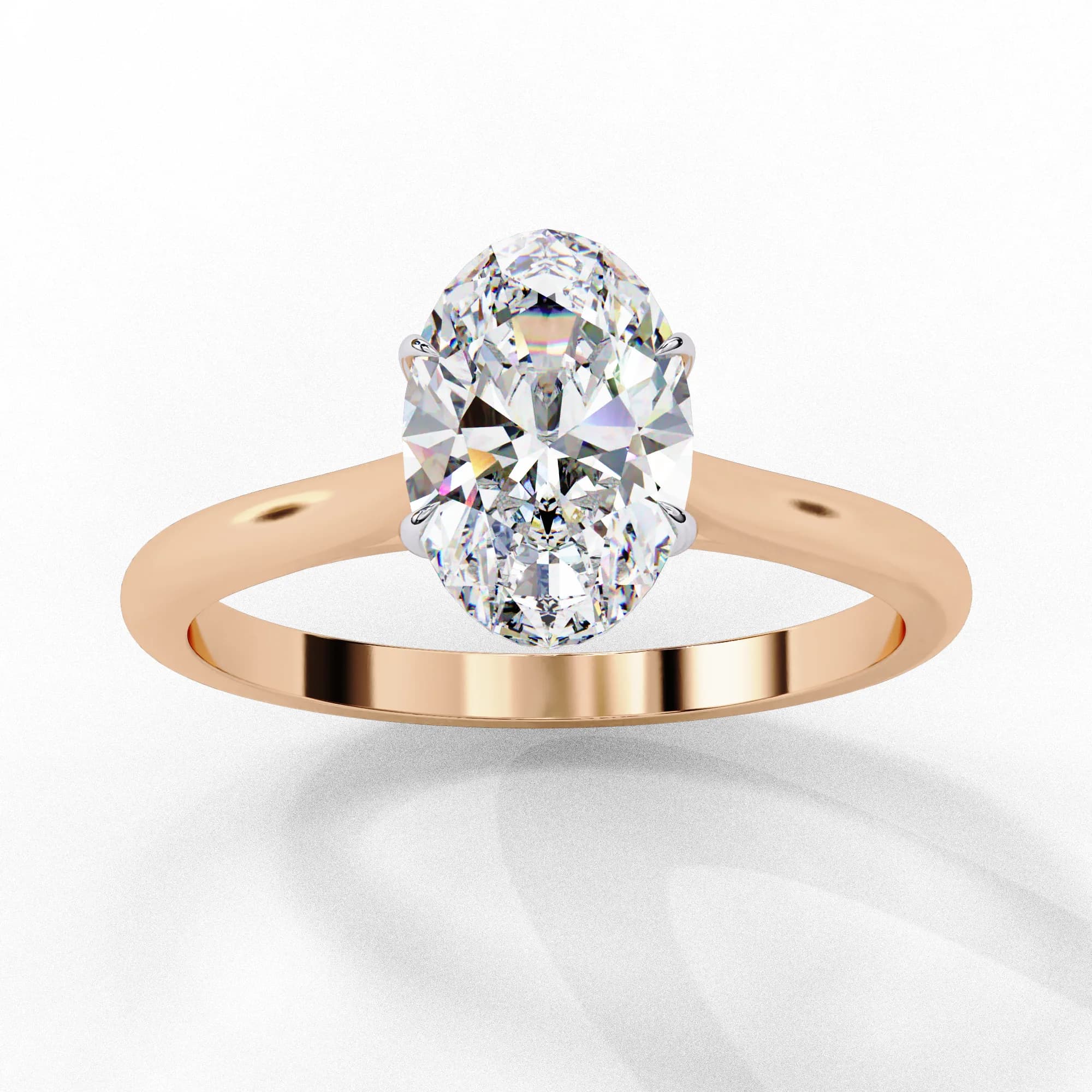 Oval lab grown diamond four-claw solitaire engagement ring in rose gold, angled view