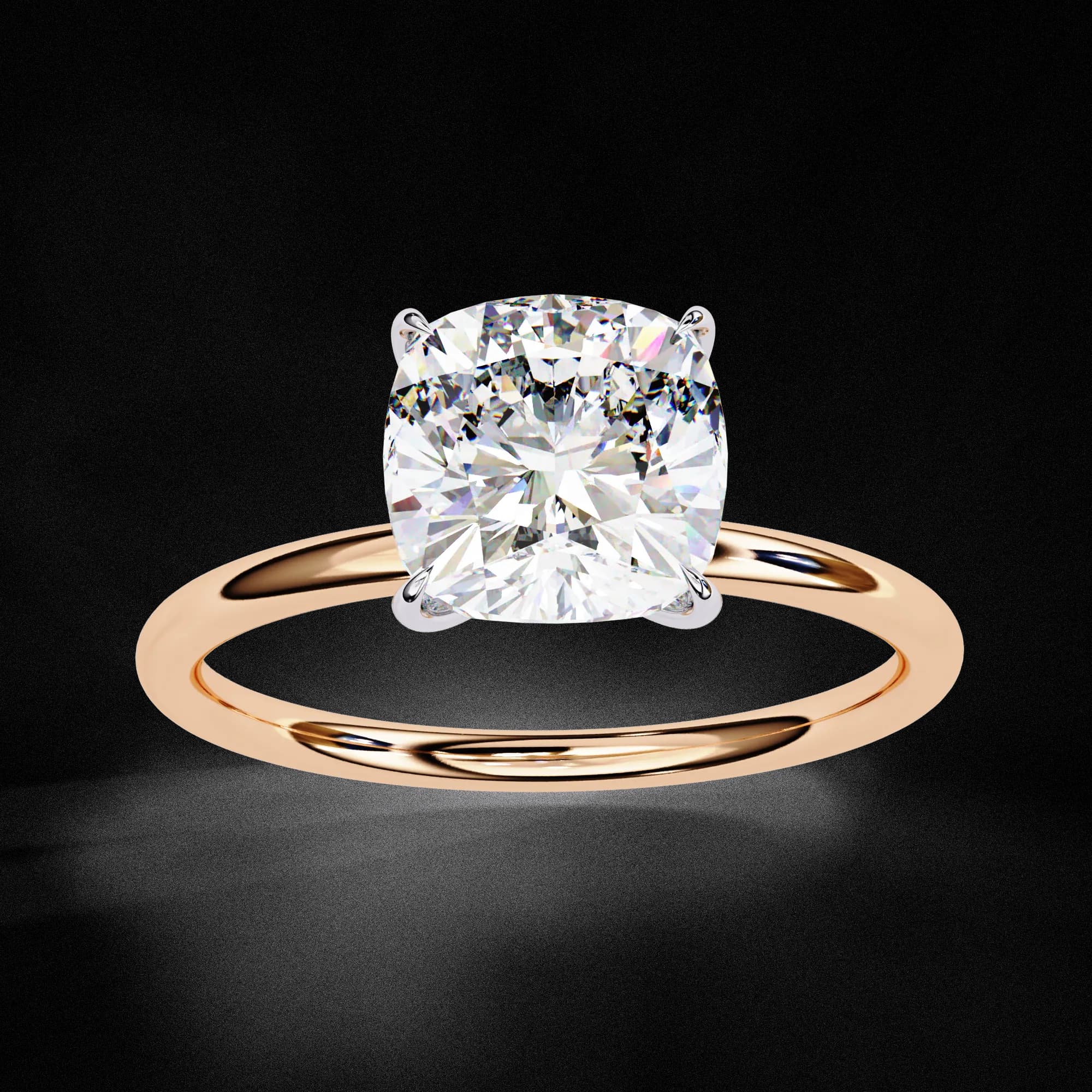 Cushion cut lab grown diamond four-claw solitaire engagement ring in rose gold, angled view