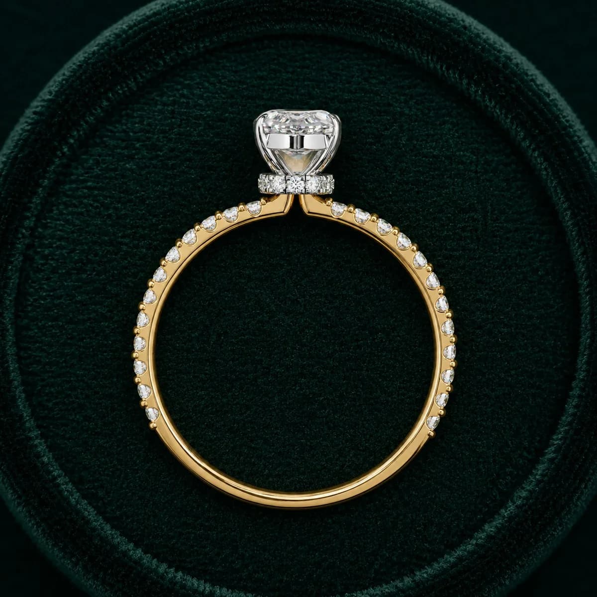 Marquise lab grown diamond hidden halo engagement ring in yellow gold standing in a green velvet ring box