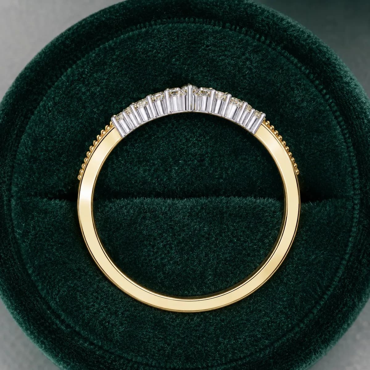 Round lab grown diamond chevron milgrain wedding band in yellow gold in a green velvet ring box