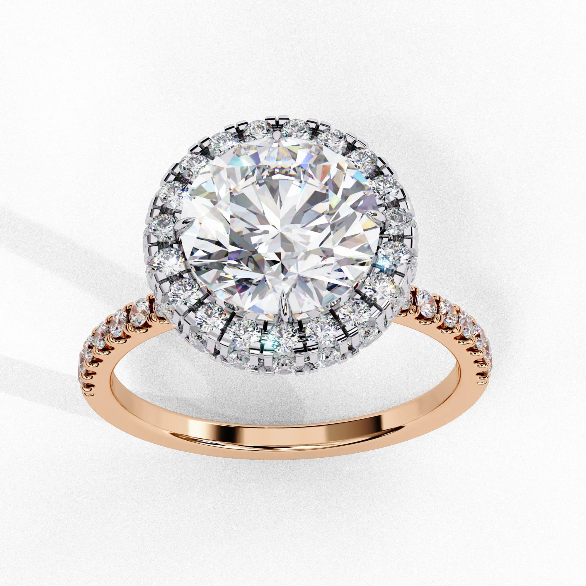 Round lab grown diamond halo engagement ring in rose gold, angled view