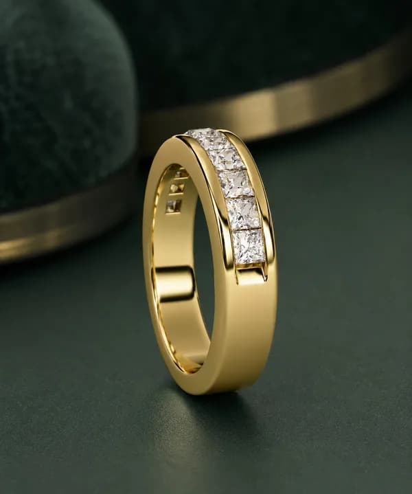 Princess cut lab grown diamond channel-set half eternity band in yellow gold standing on green velvet, side view