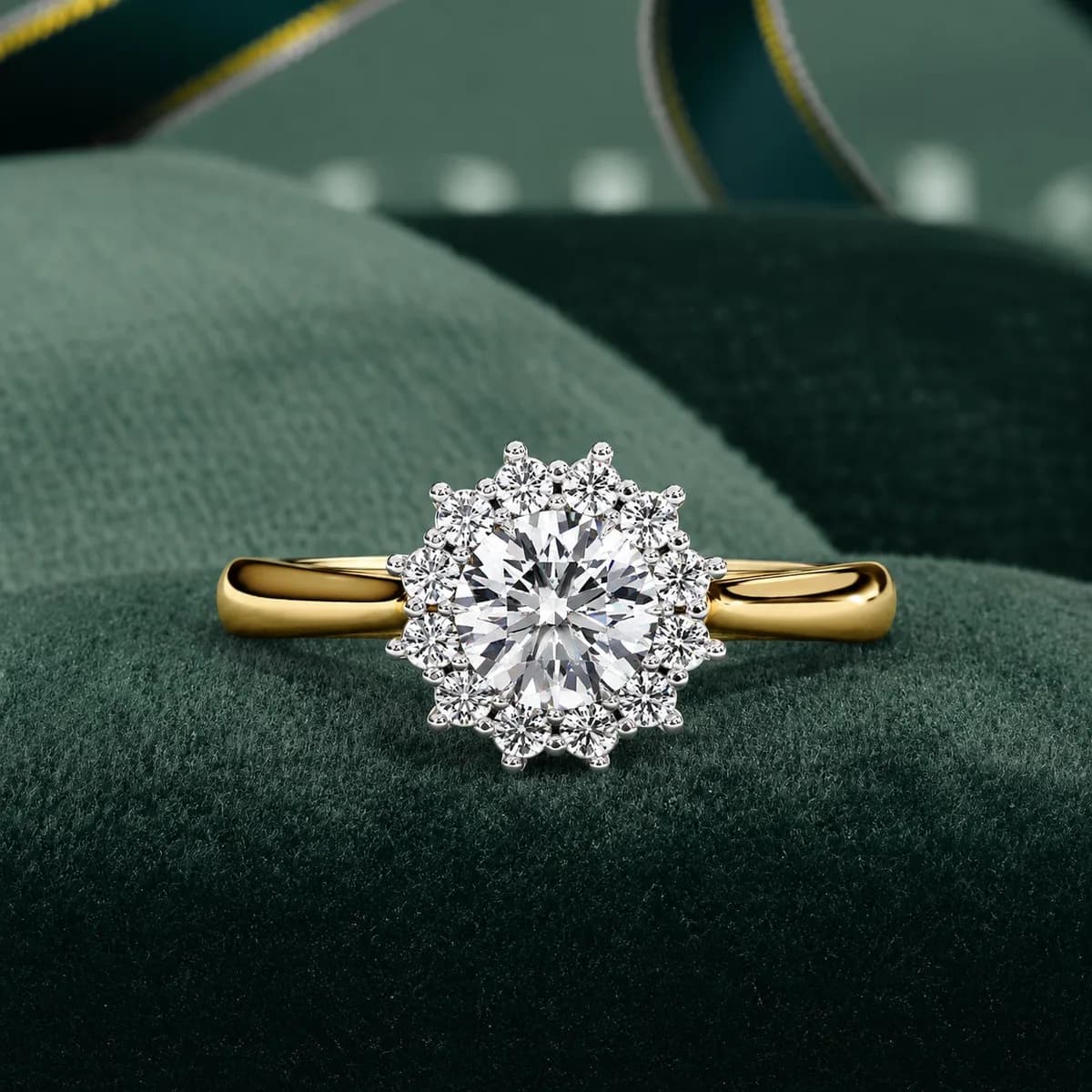 Round lab grown diamond cluster halo engagement ring in yellow gold on green velvet