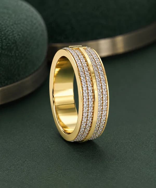 Wide four-row pavé lab grown diamond eternity band in yellow gold standing upright on green velvet, side view