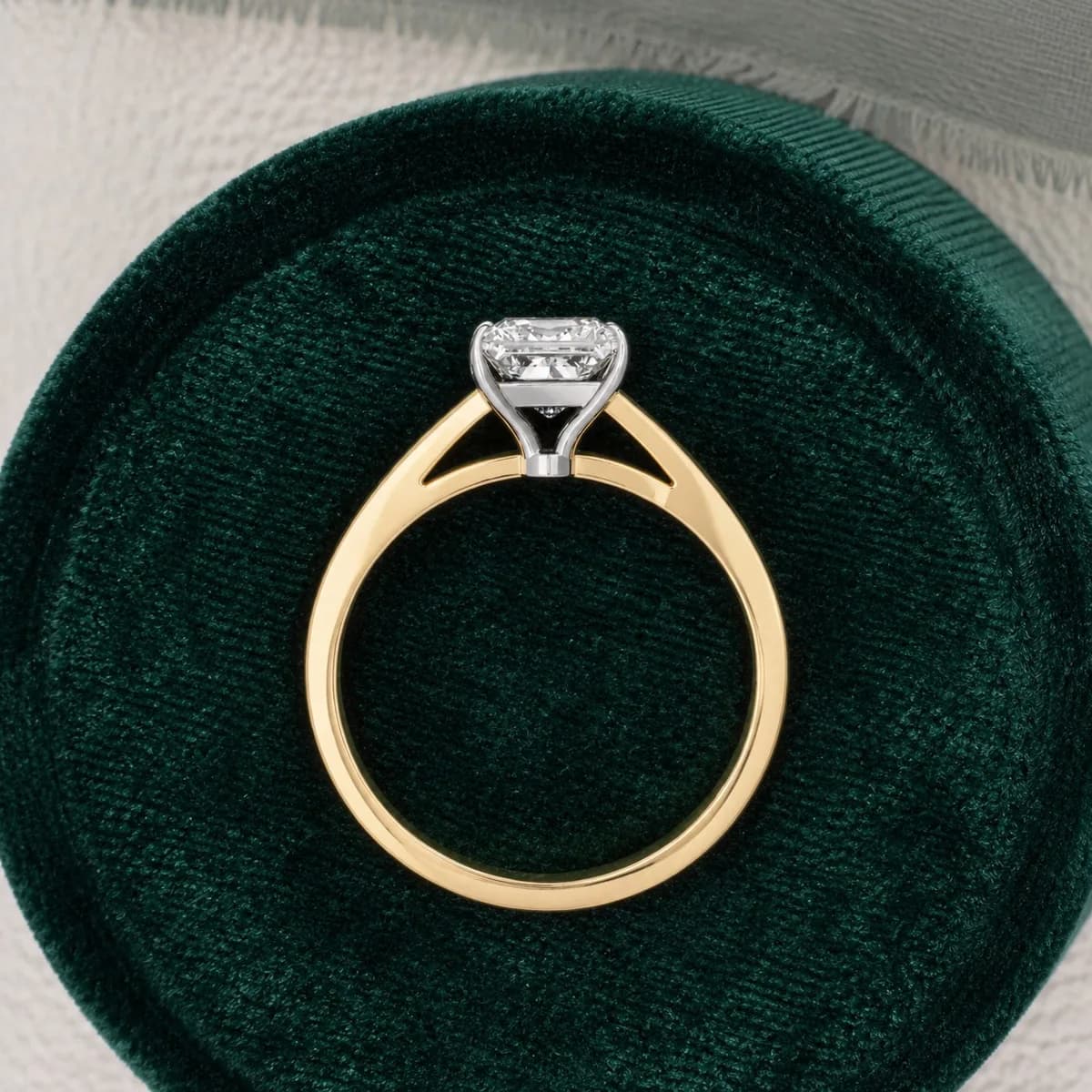 Princess cut lab grown diamond cathedral solitaire engagement ring in yellow gold in a green velvet ring box
