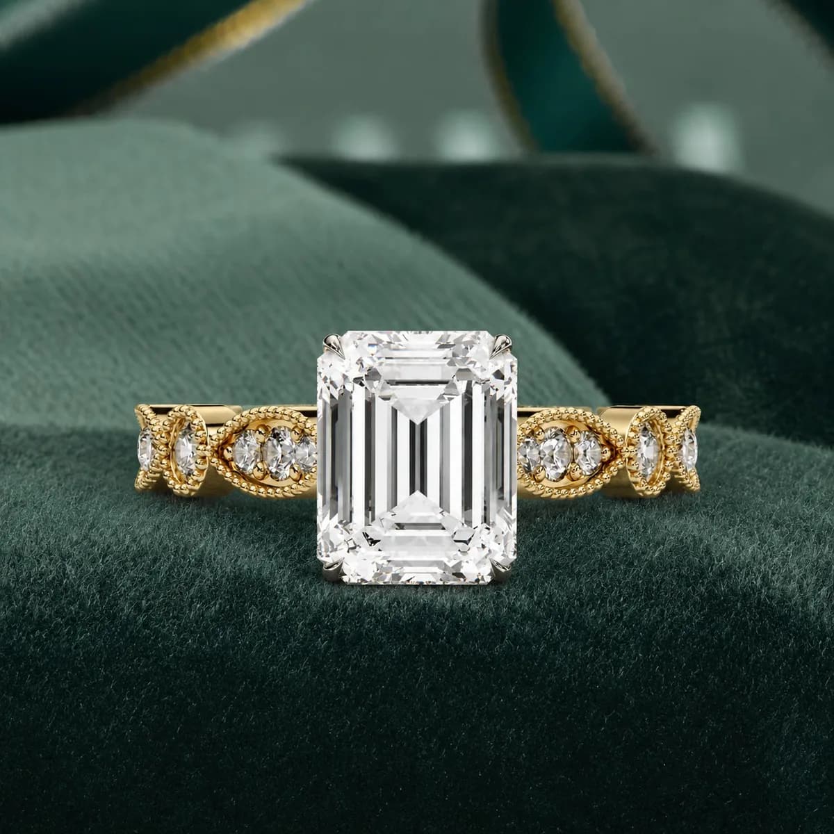 Emerald cut lab grown diamond vintage milgrain engagement ring in yellow gold resting on green velvet