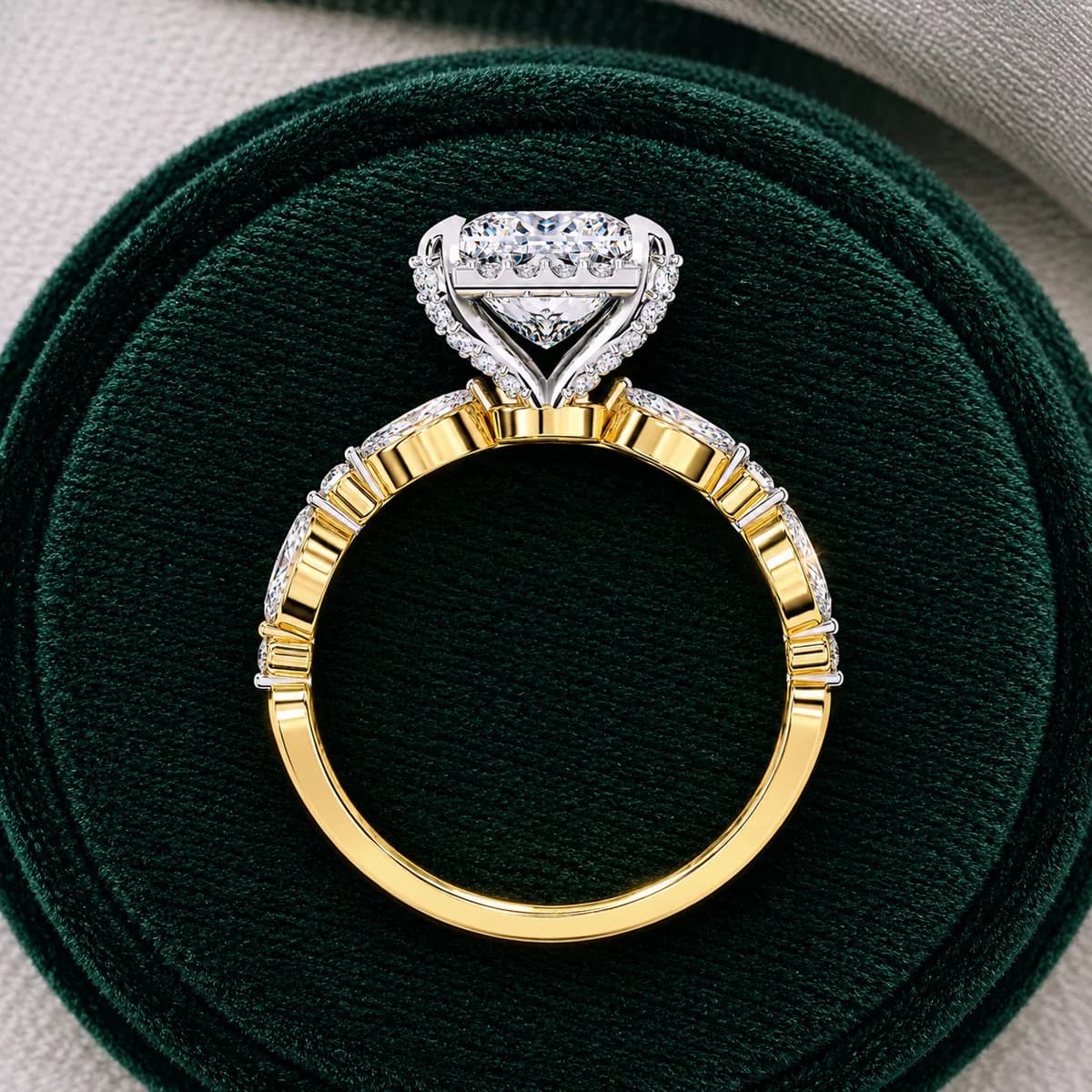Princess cut lab grown diamond halo engagement ring with marquise side stones in yellow gold in a green velvet ring box