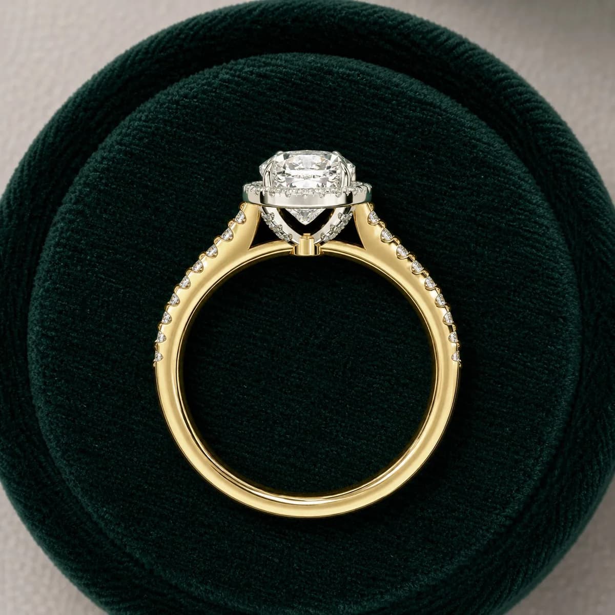 Cushion cut lab grown diamond halo pavé engagement ring in yellow gold in a green velvet ring box