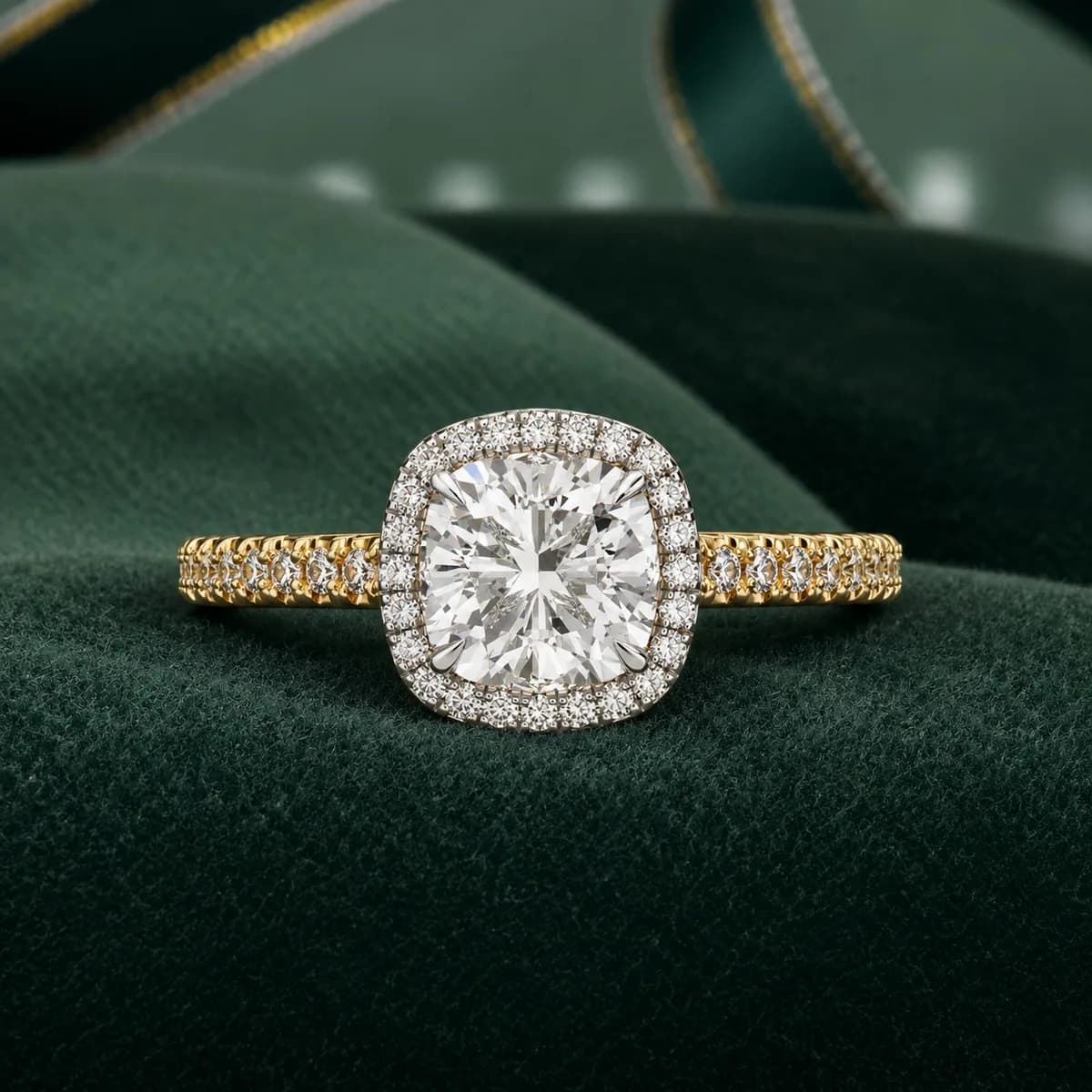 Cushion cut lab grown diamond halo pavé engagement ring in yellow gold on green velvet