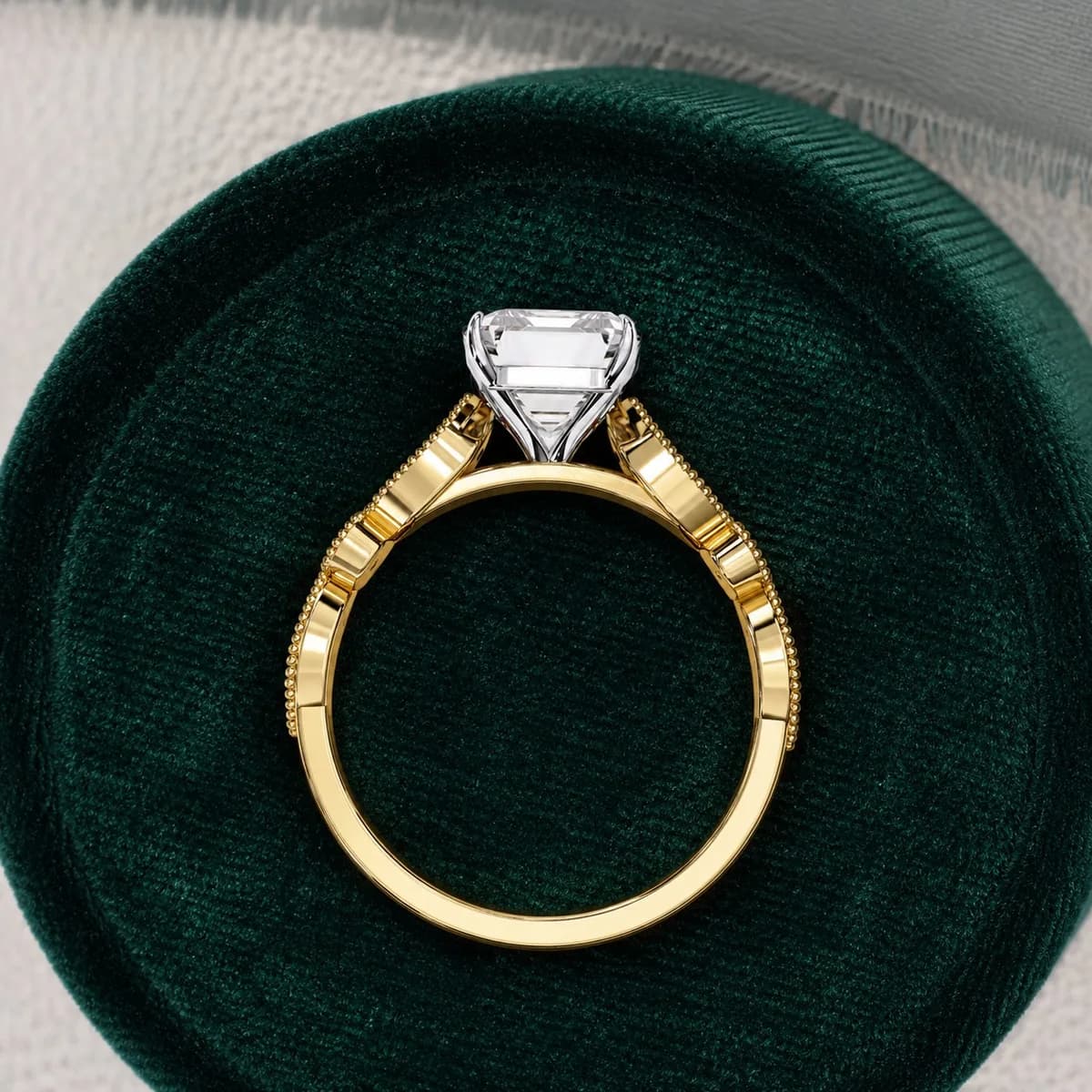 Radiant cut lab grown diamond vintage milgrain engagement ring in yellow gold standing in a green velvet ring box